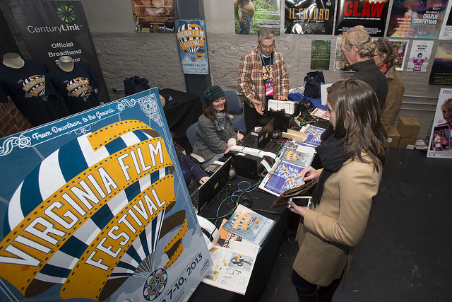 Virginia Film Festival registration desk with attendees and posters.