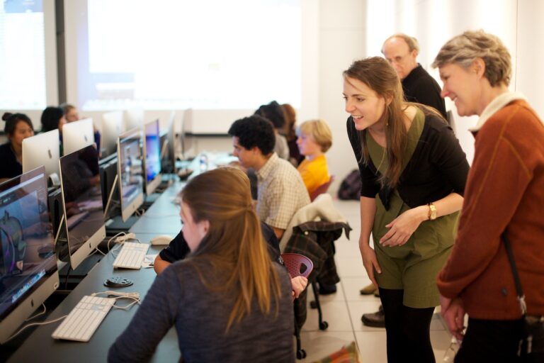 Students and instructors in a computer lab setting, possibly related to the Adrenaline Film Project.