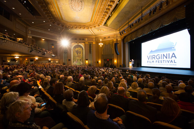 Virginia Film Festival event with large audience and stage screen.