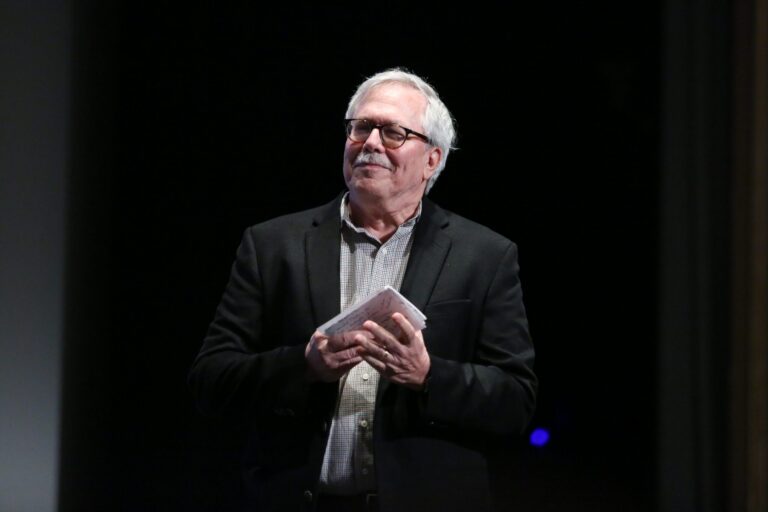 Man with glasses holding notes at Virginia Film Festival