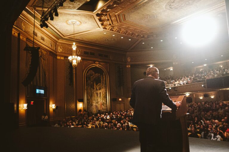 Speaker at the 2021 VAFF addressing a large audience in a grand theater.