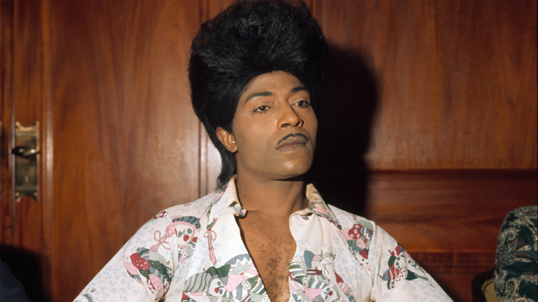 Little Richard with his signature pompadour hairstyle and patterned shirt.