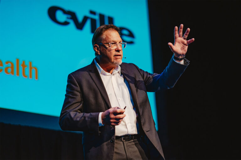 Man speaking at the Virginia Film Festival, gesturing with hands.