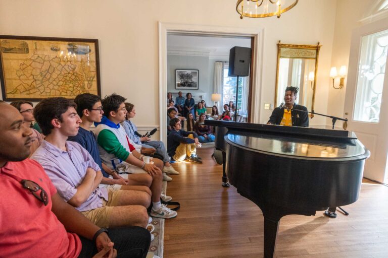 Musician performing at a Virginia Film Festival event for a seated audience.