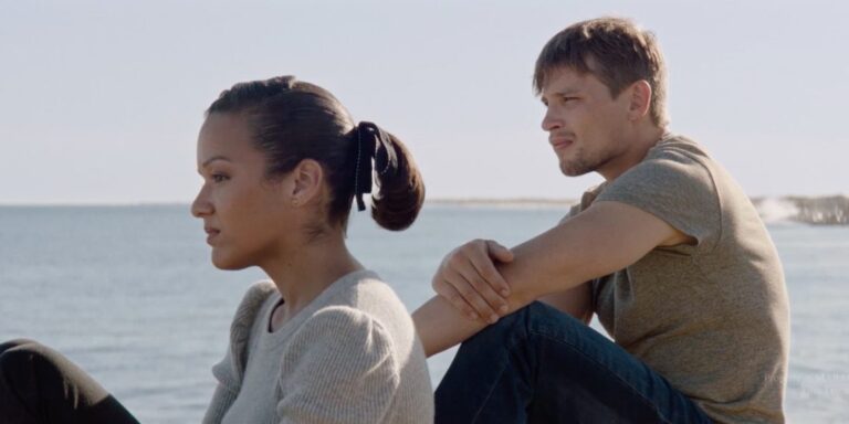 Actors in 'Breakwater' at the Virginia Film Festival, sitting by the water, looking contemplative.
