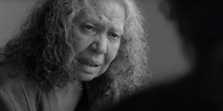 Black and white close-up of an older woman with worried expression, from 'We Shall Not Be Moved'.