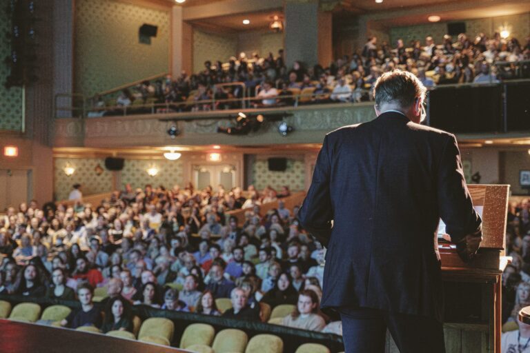 Speaker at 2025 Virginia Film Festival addressing a large audience in a theater.