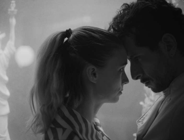 Black and white photo of a man and woman forehead to forehead, possibly from "La Cocina.