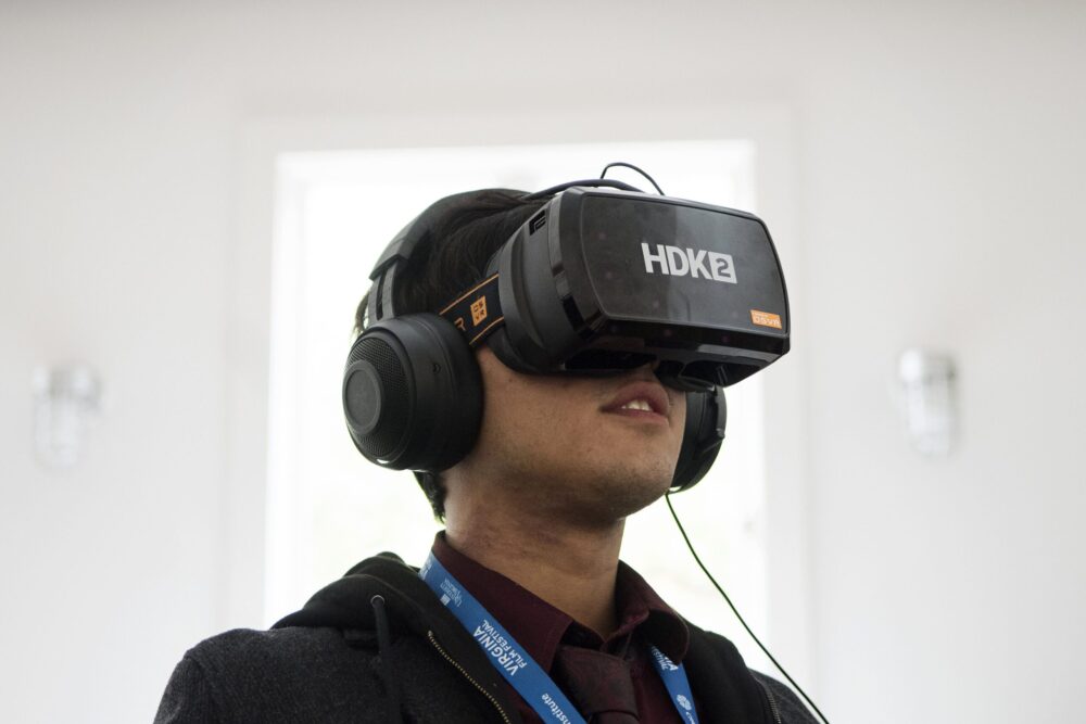 Man using HDK2 VR headset, experiencing virtual reality.