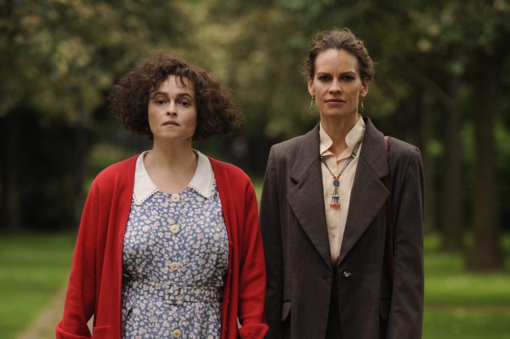 Helena Bonham Carter and Hilary Swank in "55 Steps", walking outdoors.