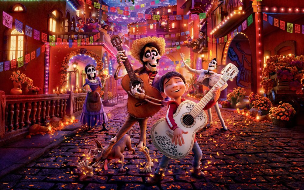 Coco movie scene: Miguel playing guitar with skeleton musicians and Dante the dog in a festive town.