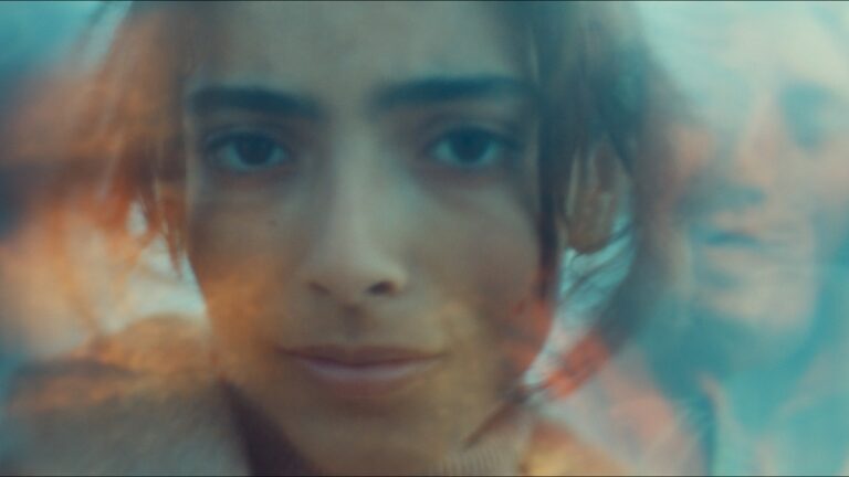 Close-up of a youth with blurred, ethereal background, possibly related to the film "Animalia.