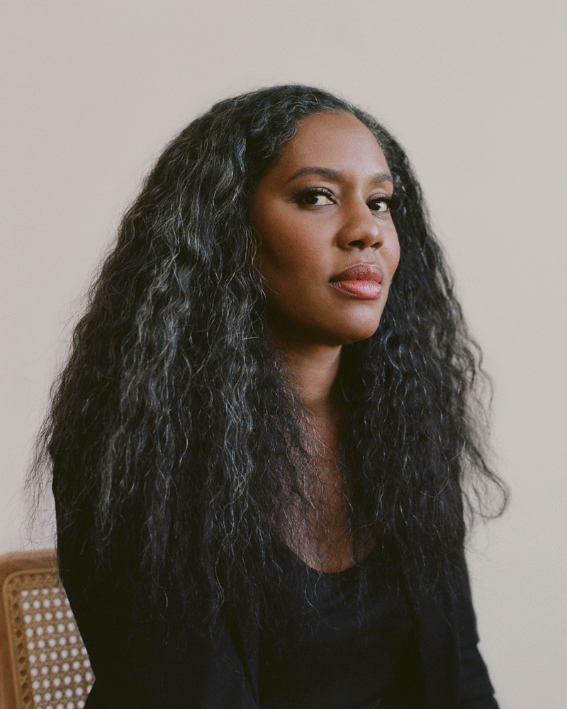Portrait of Alisa Payne with long, flowing graying hair, wearing a black top.