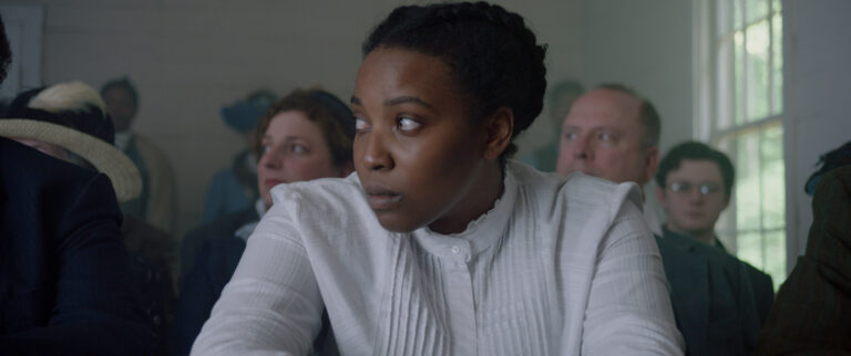 Woman looking concerned in a crowded room.