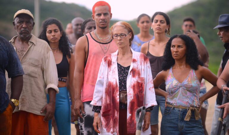Ensemble cast of "Bacurau," standing together, some looking concerned.