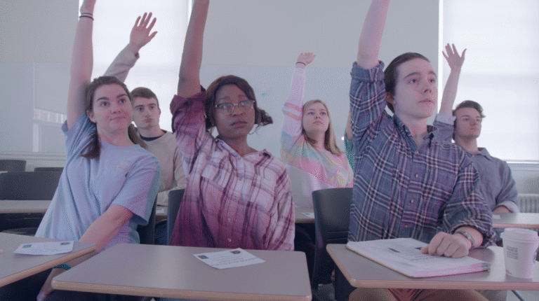 Students raising hands in a classroom