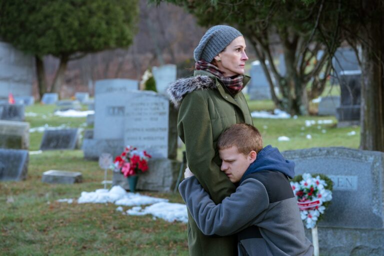 Julia Roberts in "Ben Is Back" comforting a young man in a cemetery.
