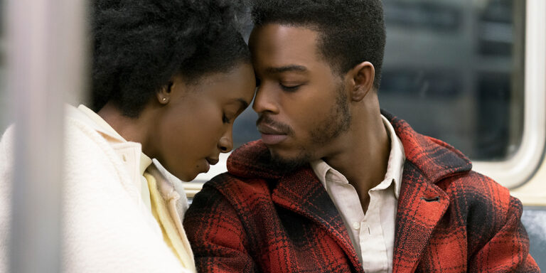 Couple embracing on a train in "If Beale Street Could Talk"