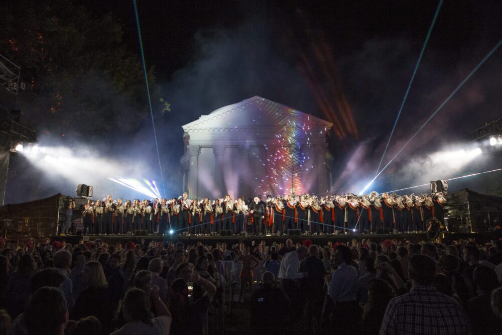 University of Virginia bicentennial celebration: brass band performing for a large crowd, with light show on the Rotunda.
