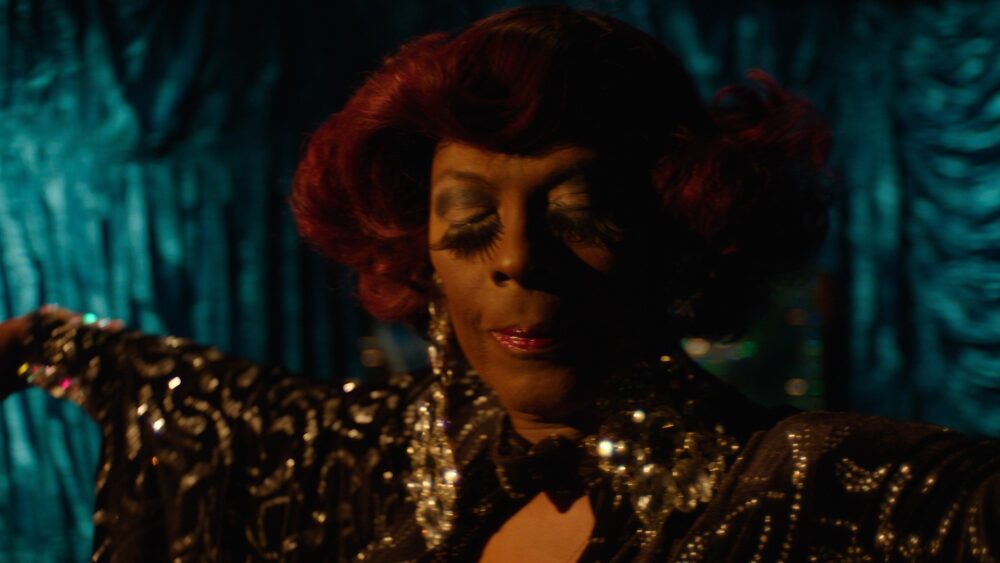 Drag queen with red hair and dramatic makeup
