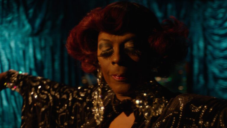 Drag queen with red hair and dramatic makeup