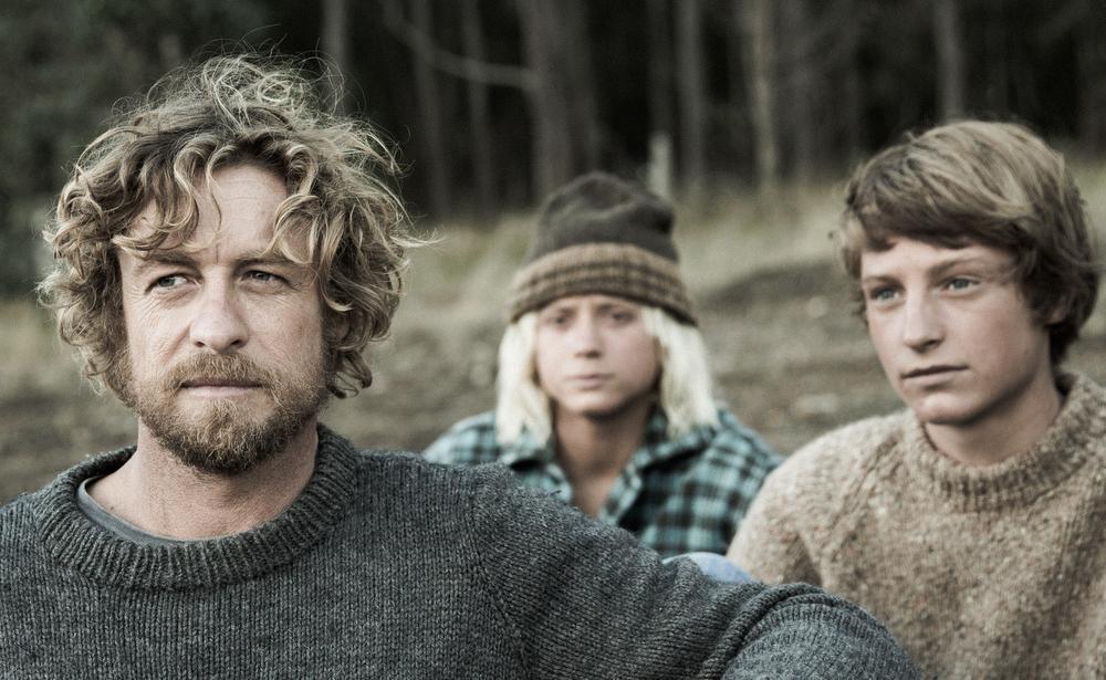 From the film Breath: A man and two young people in knitwear, looking thoughtful.