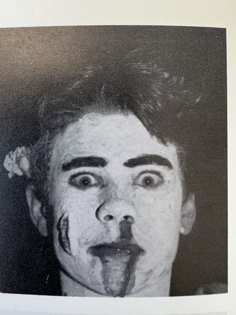 Burton Gray in costume with white face paint and dramatic makeup.