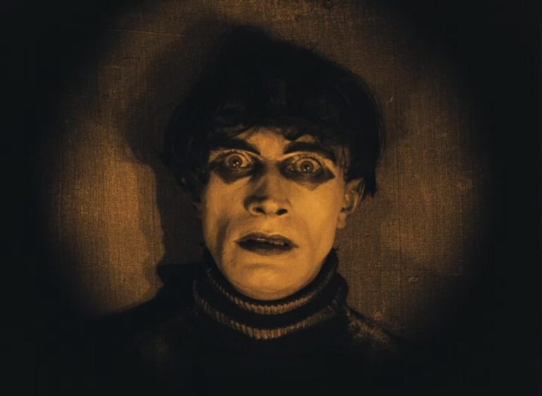 Cesare in "The Cabinet of Dr. Caligari," a silent film character with dark eye makeup and a haunted expression.