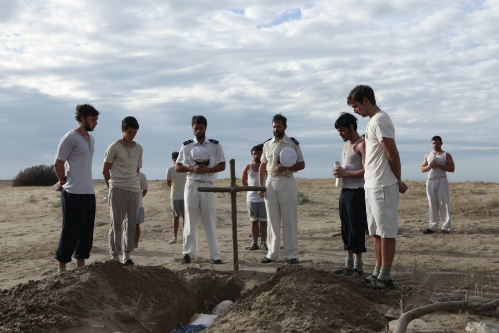 Mourners at a graveside during "Coming Home" ceremony.