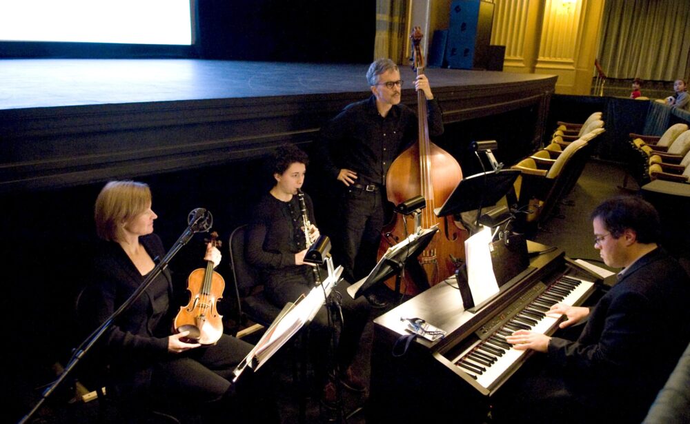 Musical quartet rehearsing for a composer symposium performance.