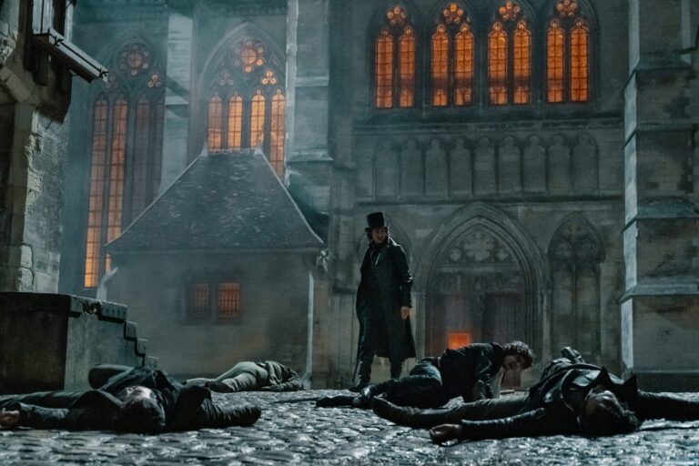 The Count of Monte Cristo stands over fallen men in a courtyard.