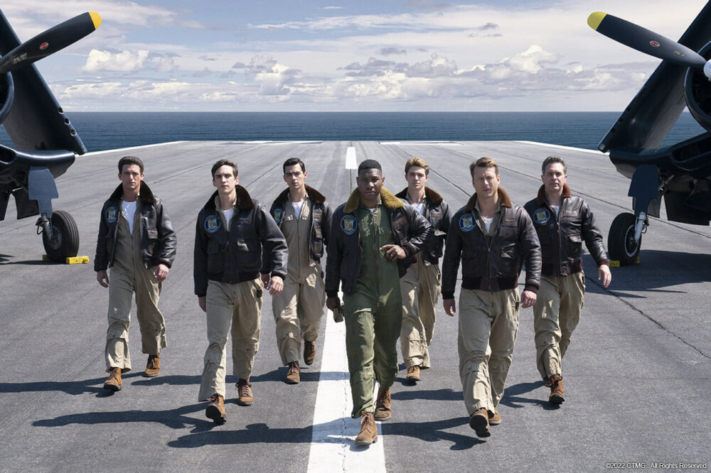 Devotion movie scene: Pilots walk on an aircraft carrier deck.
