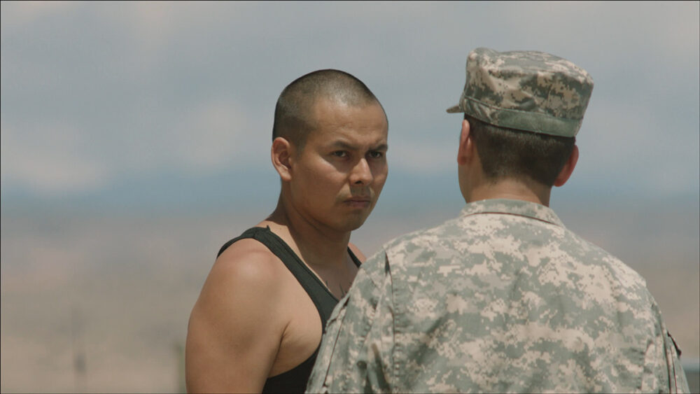 Man in tank top confronts soldier in Drunktown's Finest