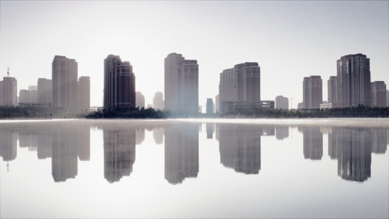 Cityscape reflecting on water.