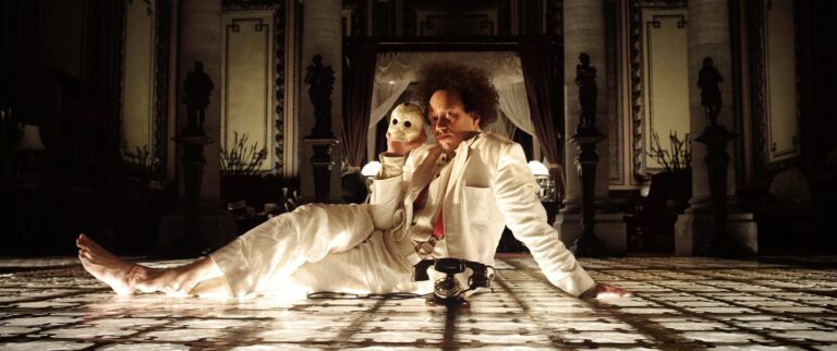 Eisenstein in Guanajuato: Man in white suit with mask and phone
