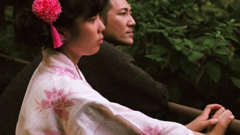 Woman in yukata and man looking pensively in "Family Romance, Llc" film still.