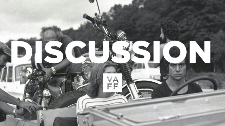 Farsi film discussion: Vintage motorcycle and group of people. VAFF.