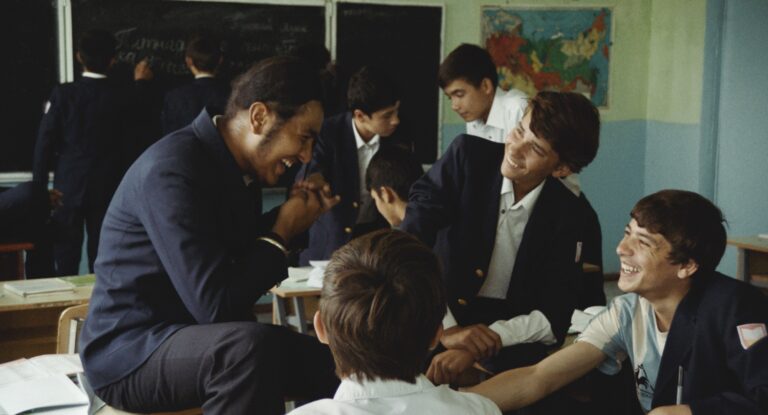 Boys laughing in a classroom from "Parwareshgah (the Orphanage)"