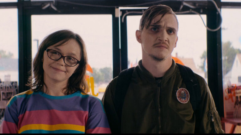 Still from "Dinner in America" featuring characters Patty and Simon.