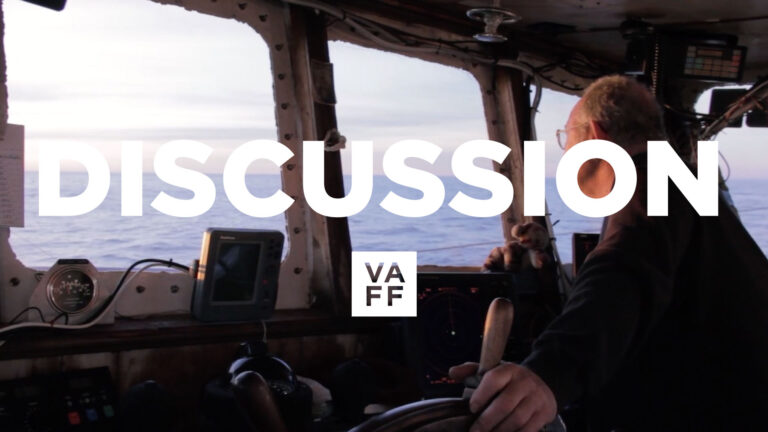 Fish & Men discussion: Fisherman at the helm of a boat, navigating the ocean.