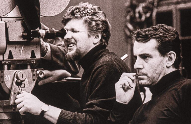 Director Miloš Forman filming, with another man beside him, in a behind-the-scenes shot.