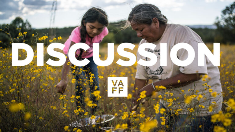 Gathering discussion: Woman and child collecting plants in a field. VAFF.