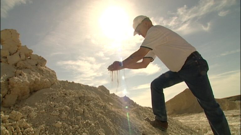 Man examining soil at a construction site.