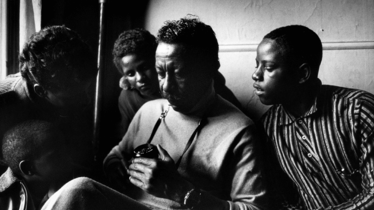 Gordon Parks surrounded by children, possibly inspired by "A Choice of Weapons.