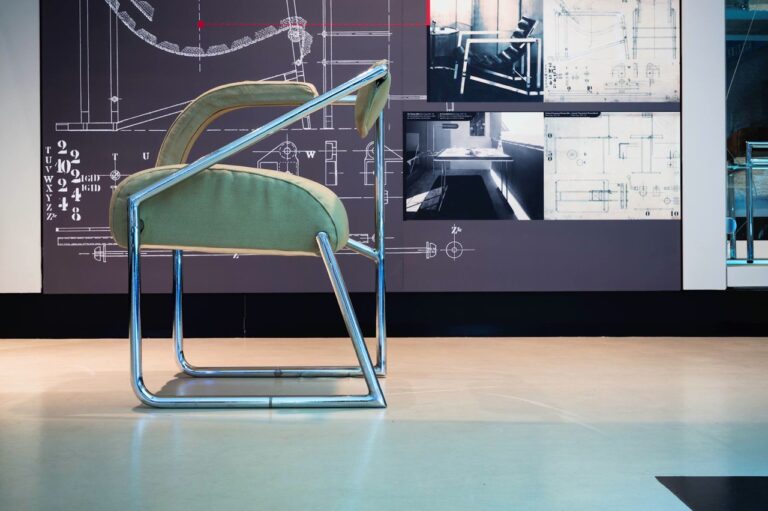 Chrome cantilever chair against a design blueprint backdrop. Modern "Gray Matters" in furniture design.
