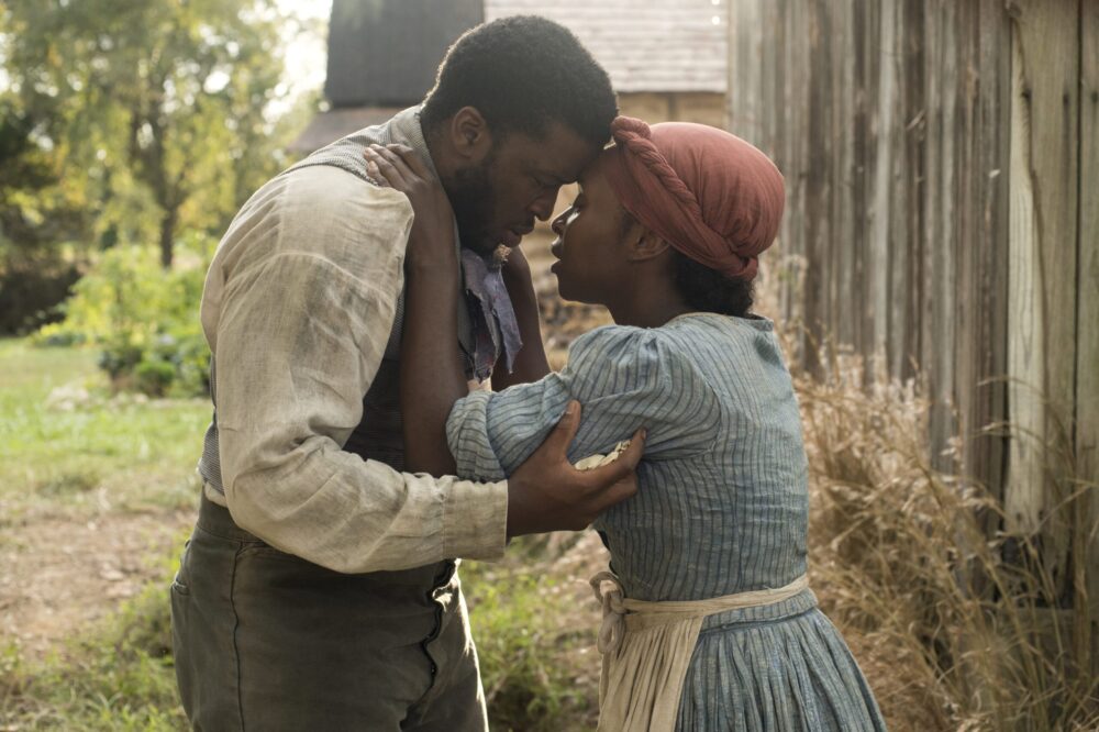 Harriet movie scene: A woman embraces a man with emotion.