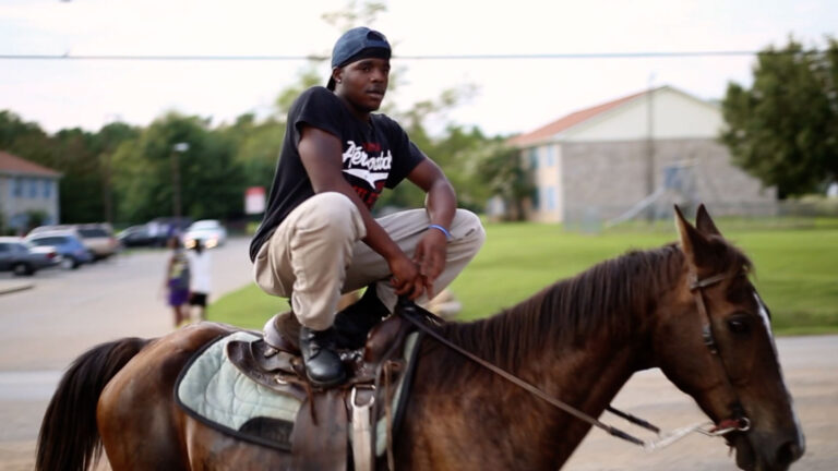 Man riding a horse in Hale County, Alabama.