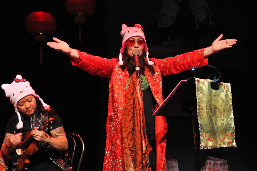 Musicians performing in Hello Kitty hats at a fun show.