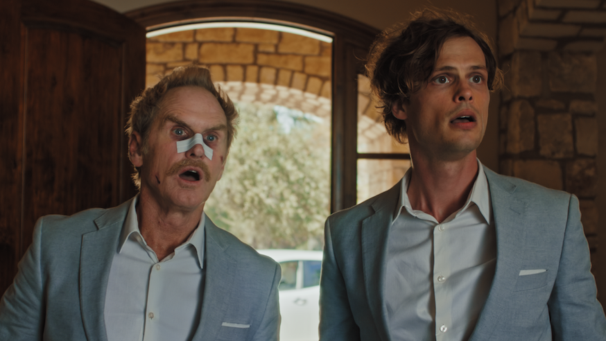 Surprised men in suits, one with a bandage on his nose