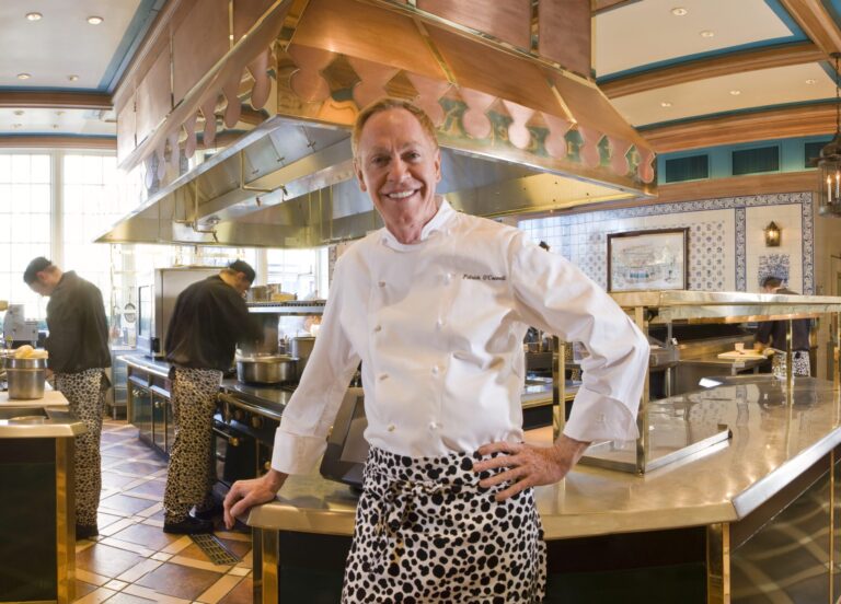 Chef Patrick O'Connell in The Inn at Little Washington kitchen, smiling.